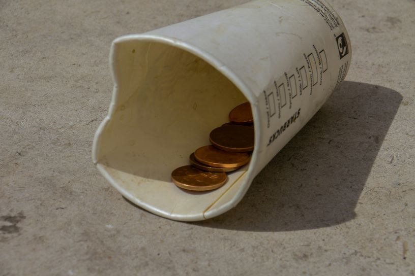 cardboard cup with coins