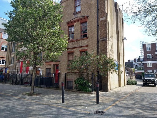 Tall brick building with red paitwork