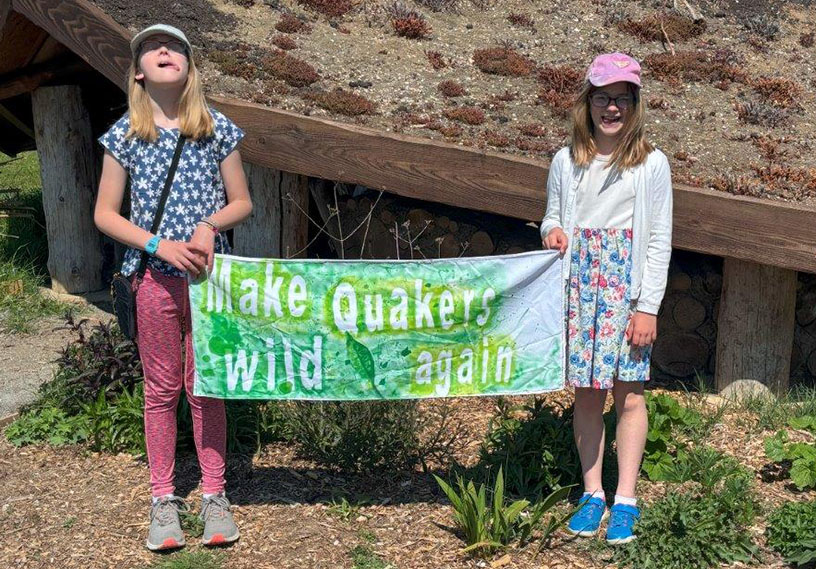 Two girls holding up a banner