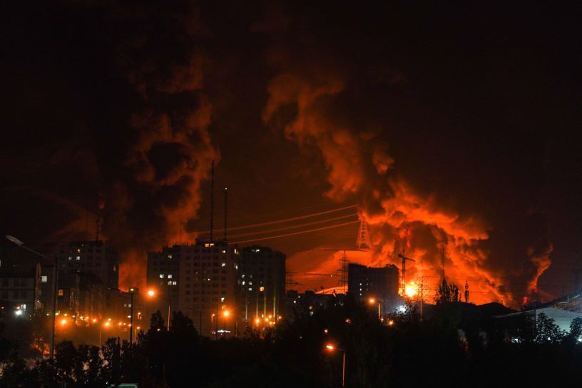 Billowing flames over an oil terminal in a night sky