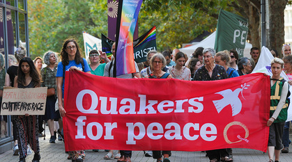 People marching with a banner that reads 'Quakers for peace'