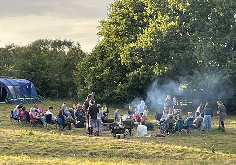 People gathered outdoors in a large circle