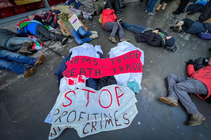 people lying outside under banner