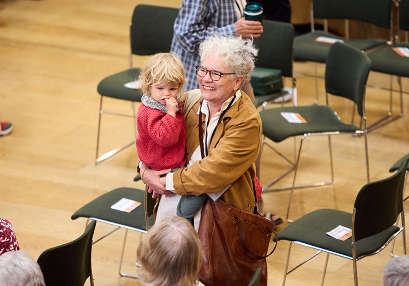 Smiling woman carry a small child