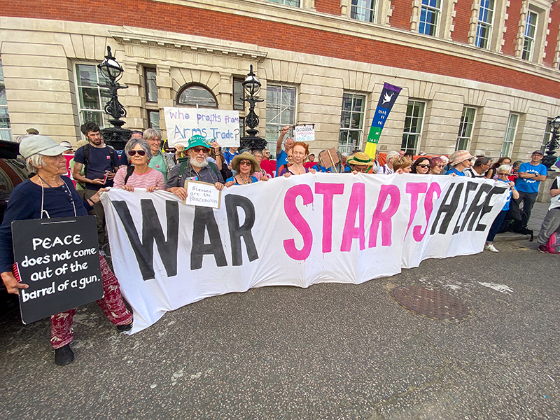Friends resisting DSEI arms fair with a banner that says WAR STARTS HERE. Photo: Michael Preston for Quakers in Britain  