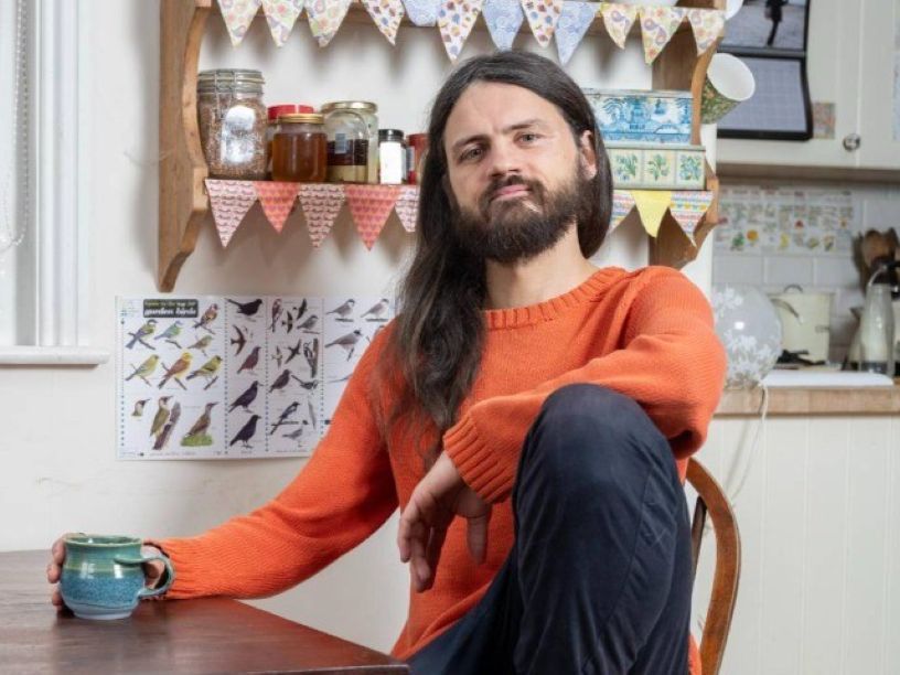 Man in orange jumper